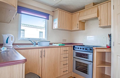 Llanllwchaiarn House | Spacious and comfortable 12ft-wide caravan with one double and two twin.