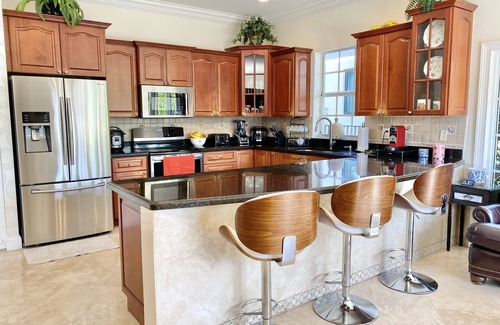 Garden Isles House | Spacious, beautiful 4 bedroom house with heated pool 10 min from Beach.