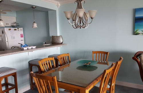 Wilmington Beach Condo | Spacious condo with large deck to view the beautiful ocean just a few feet away.