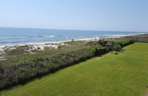 Wilmington Beach Condo | Spacious condo with large deck to view the beautiful ocean just a few feet away.