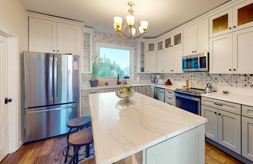 Gardiner House | Spacious home with river views, hot tub, covered porch, deck, grill, & W/D