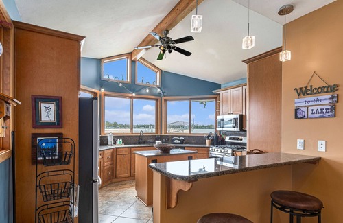 Paw Paw Lake House | Spacious lakefront home with a hot tub, private beach, washer/dryer, & AC