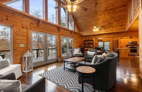 Big Creek Cabin | Spacious waterfront property with deck, hot tub, fireplace, & central AC