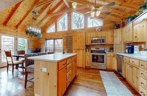 Big Creek Cabin | Spacious waterfront property with deck, hot tub, fireplace, & central AC