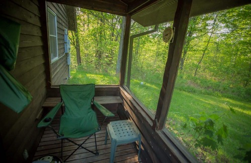 Finlayson Cabin | Spiral Staircase Leads To The Lofted Bedroom With Wall To Wall Knotty Pine.