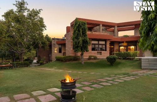 Dwarka Villa | StayVista at The Cityscape with Lawn & Pool