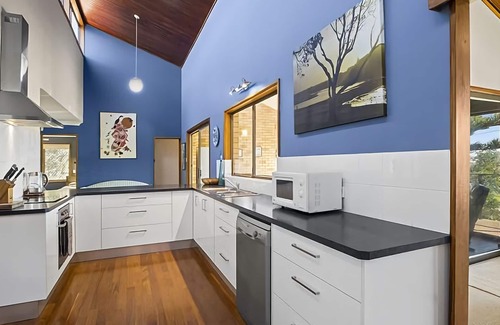 Sawtell House | Step out onto the sunny balcony of Peninsula - a spacious beachside home with superb ocean views.
