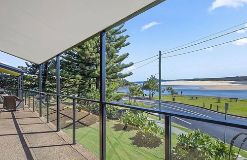 Sawtell House | Step out onto the sunny balcony of Peninsula - a spacious beachside home with superb ocean views.