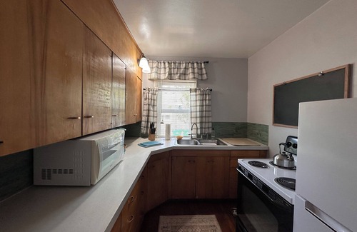 Sheridan House | "Steps from downtown and the park, this cozy mid-century hideaway offers comfort, charm, and a private outdoor escape."