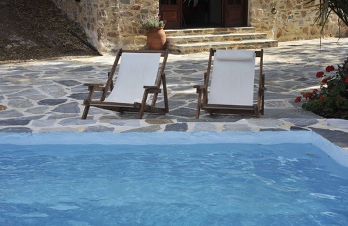 Syros Cottage | Stone-built studio under two Eucalyptus trees.
