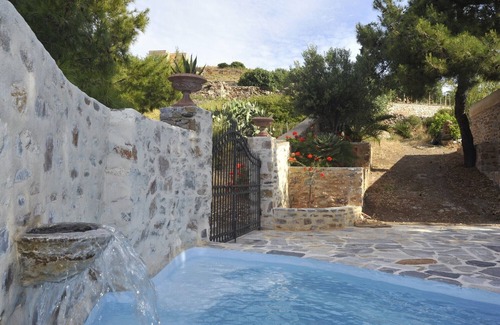 Syros Cottage | Stone-built studio under two Eucalyptus trees.