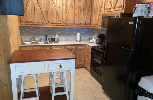 Porum Cabin | Studio cabin #3 with lake view and boat dock access, outdoor seating.