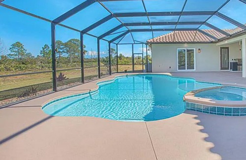 Grant-Valkaria House | Stunning Mediterranean-style vacation home w/ fabulous spillover hot tub/pool!