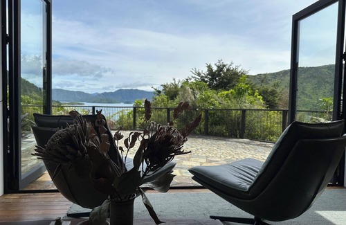 Whatamango Bay House | Stunning sea views from every room, an art filled retreat & drive on access