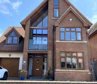 Herne Bay House | Stylish contemporary seaside holiday home with 5 bedrooms, sea view, parking and EV point