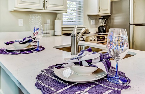 American Beach Condo | Stylish & sun-filled retreat with large patio & fireplace - near beaches & golf