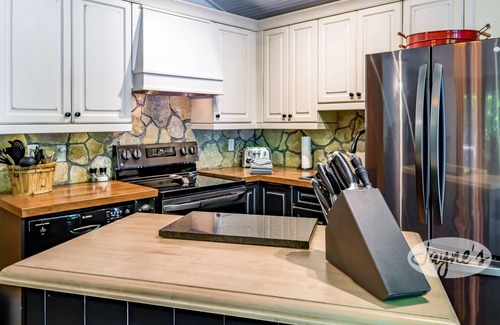 Seguin Cottage | Sunrises! Hot tub! Outdoor Kitchen! Spacious beach! Multiple outdoor fire pits!