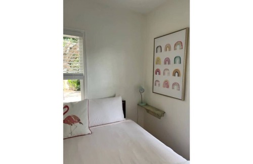 Mango Groves Cottage | Surf Inn our Beachy Cottage- King Bed w/Fenced Patio