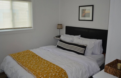 Ludington Cottage | Swan on the Lake with Kayaks, lake frontage, fire pit and screened in porch