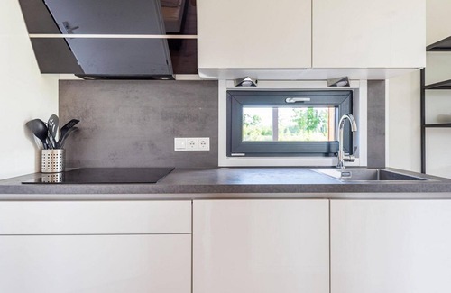 Kotten House | The 6-person holiday villa Amalia with a private sauna has a spacious living room, an open kitchen, three bedrooms, and a spacious terrace.