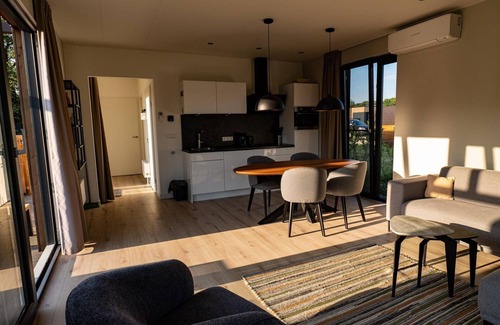 Kotten House | The Amalia is a 4-person holiday home with a cozy and homely living room with an open kitchen, 2 bedrooms, and a spacious outdoor area.
