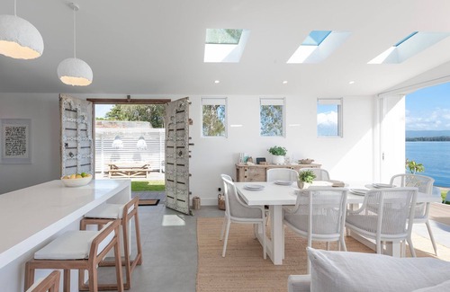 Bonnells Bay Apartment | The Boathouse- Unwind at this tranquil, absolute waterfront, luxury Boathouse nestled on the edge of