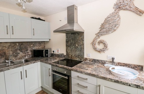 St. Florence Cottage | THE COACH HOUSE, pet friendly, with pool in St Florence