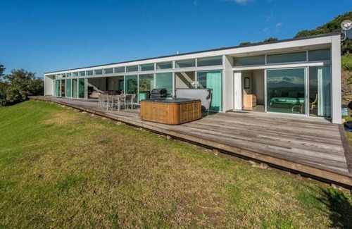 Mangawhai House | The Glass House - Modern, pet-friendly designer holiday home with spectacular views and spa pool