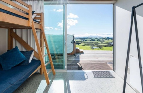 Mangawhai House | The Glass House - Modern, pet-friendly designer holiday home with spectacular views and spa pool