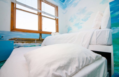Queens Condo | The High Tide Studio #6 Studio Bedroom Hotel Room by RedAwning