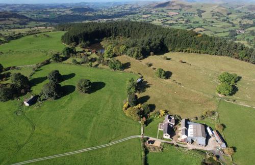 Oswestry House | The Nook at Pentregaer Ucha, with tennis court & lake.