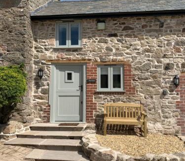 Oswestry House | The Nook at Pentregaer Ucha, with tennis court & lake.