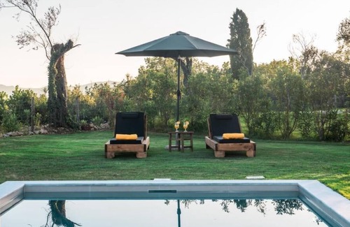 Ano Korakiana Villa | The villa's large private garden leads directly to the outdoor private pool.