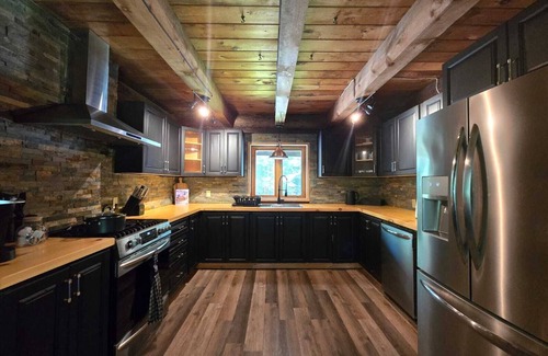 Lake St. Peter Cottage | The Wooded Oasis - Cozy Winter Cottage w/Hot Tub & Sunken Firepit