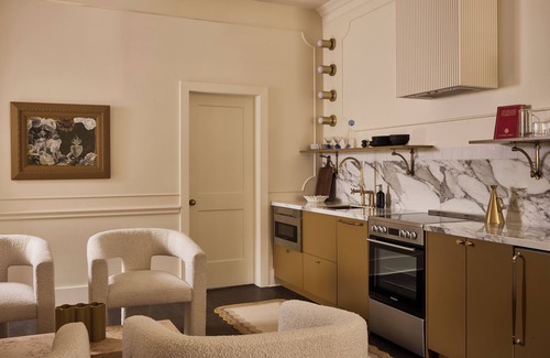 Stratford Hotel | This neutral flat packs a punch with a unique and interesting feature—a round king size bed!