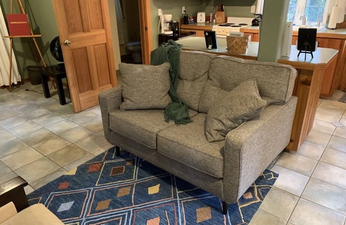 Ashford Cabin | This romantic cabin at Mt. Rainier is a one room cabin with private hot tub right on Copper Creek. It has a queen bed and a queen Murphy bed. Walk to Copper Creek Restaurant. Beautiful woodland setting.