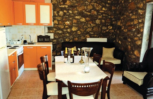 Paralia House | This stone vacation property on two levels is one of three terraced houses sharing a swimming pool.