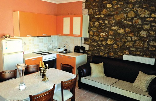 Paralia House | This stone vacation property on two levels is one of three terraced houses sharing a swimming pool.