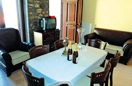 Paralia House | This stone vacation property on two levels is one of three terraced houses sharing a swimming pool.