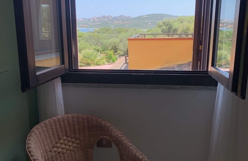 Porto Pollo Apartment | Three-room apartment with large sea view terrace, garden & barbecue.