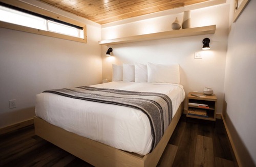 Coos Bay Cabin | Timber Haus w/Loft - Timber Haus, one of our newest (and largest) cabins, is full of light with full windows and skylights. Queen bedroom and upper two-twin loft. Sleeps 4.