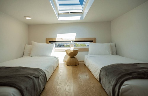 Coos Bay Cabin | Timber Haus w/Loft - Timber Haus, one of our newest (and largest) cabins, is full of light with full windows and skylights. Queen bedroom and upper two-twin loft. Sleeps 4.