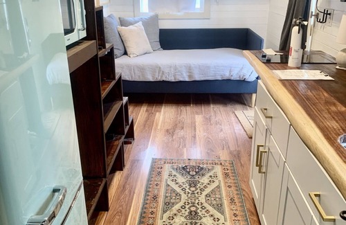 Montrose House | Tiny home with one lofted queen bed and twin sized day bed.