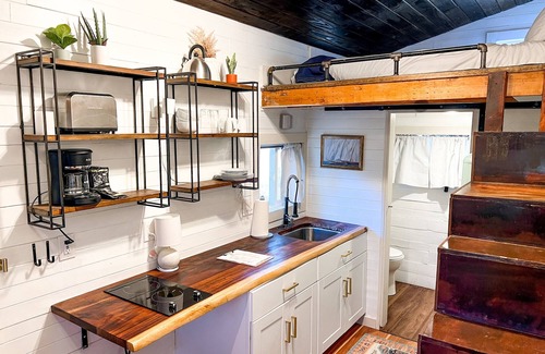 Montrose House | Tiny home with one lofted queen bed and twin sized day bed.