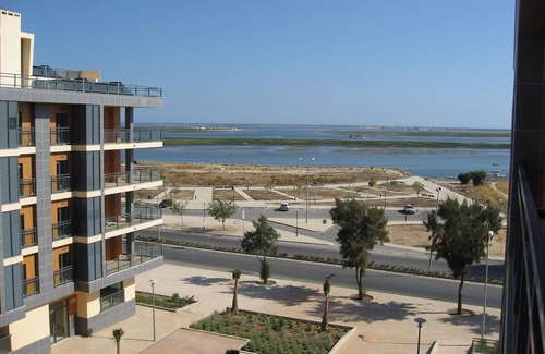 Olhao Apartment | Top-floor frontline apartment, sea views, rooftop pool, easy walk historic Olhao