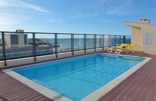 Olhao Apartment | Top-floor frontline apartment, sea views, rooftop pool, easy walk historic Olhao