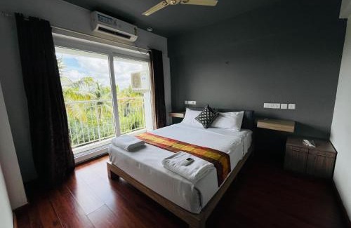 Nedumbassery Apartment | Transit suites by Habitat
