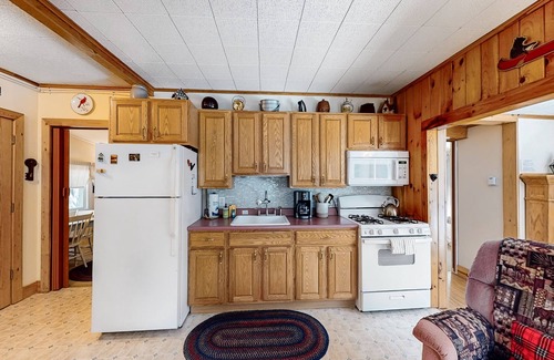 Warrensburg Cottage | Tree-lined dog-friendly cottage with wrap-around deck, grill, & gas fireplace