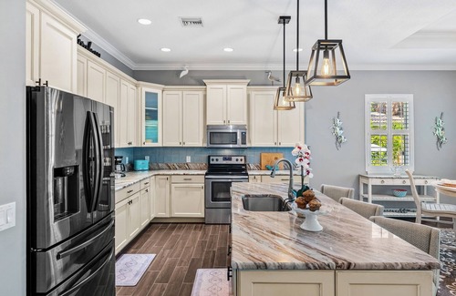 Cocoa Beach House | Tropical Backyard Oasis w/Screened in Outdoor Patio, Pool, Gas Firepit & BBQ Grill!