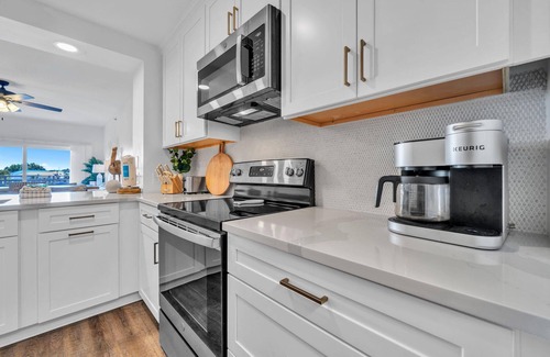 Waterside Village Condo | Tropical Retreat with Canal Views, Beach Service, Pool, Hot Tub